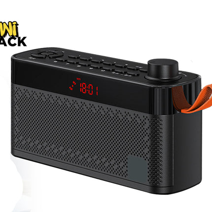 A black portable Bluetooth speaker radio with a digital red LED display showing 18:01 and an orange carrying loop handle, shown on a white background with a Kiwi Shack logo in the top left corner.