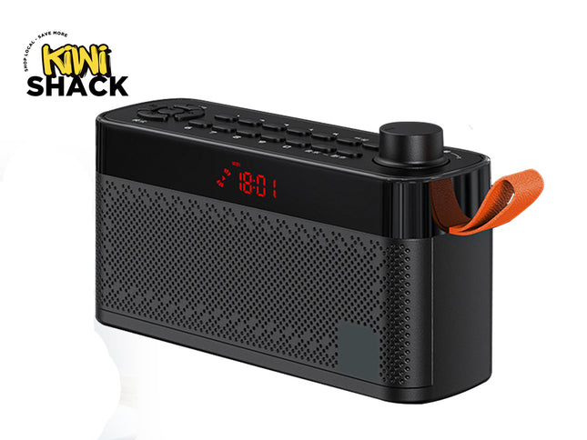 A black portable Bluetooth speaker radio with a digital red LED display showing 18:01 and an orange carrying loop handle, shown on a white background with a Kiwi Shack logo in the top left corner.