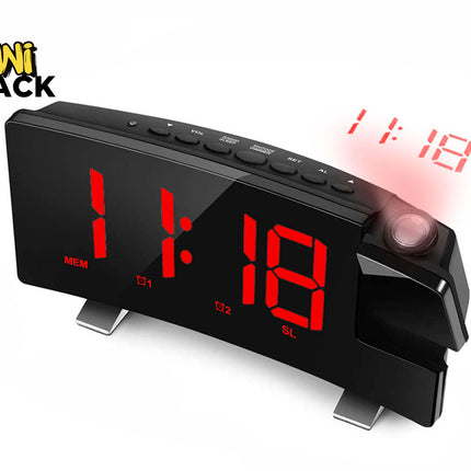 A curved black digital projection alarm clock featuring a large red LED time display and a rotating projector lens that casts the time onto a surface, featuring a "Kiwi Shack" logo in the top left corner.