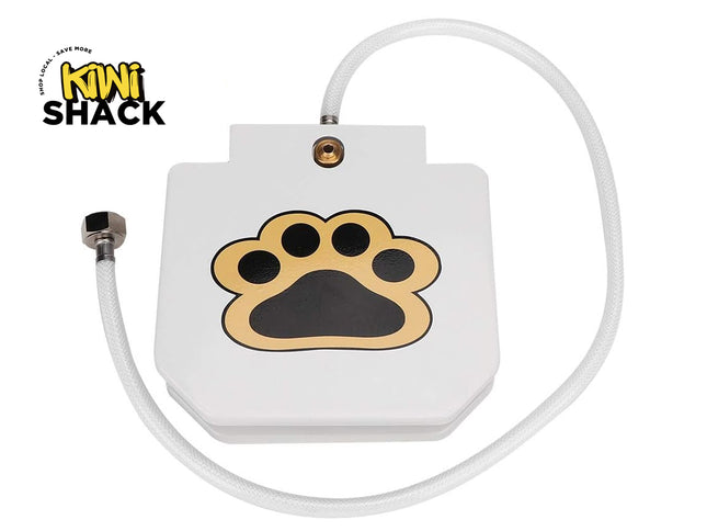 A white rectangular pet waterer or feeder with a gold and black paw print graphic on the front, connected to a white hose. The Kiwi Shack logo is visible in the top-left corner.