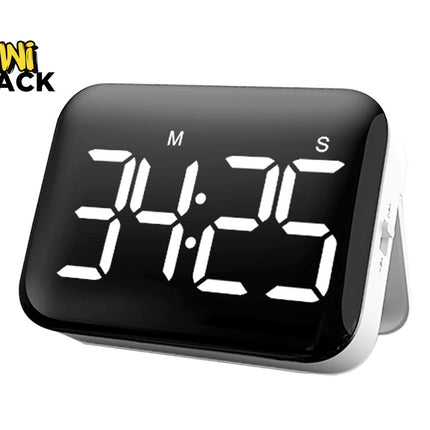 A black digital kitchen timer with a white LED display showing "34:25" and "M" and "S" labels above the digits, resting on a white stand against a plain background, with the "Kiwi Shack" logo in the top left corner.