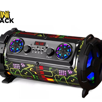 A cylindrical portable Bluetooth speaker with a black body, colorful graffiti-style graphics in green, yellow, and red, and illuminated blue LED accents on the speaker grilles and rear fans. The Kiwi Shack logo is visible in the top-left corner.
