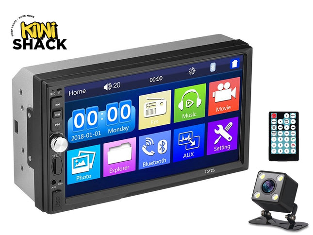 Car multimedia system with touchscreen display, camera, and remote control on a white background.