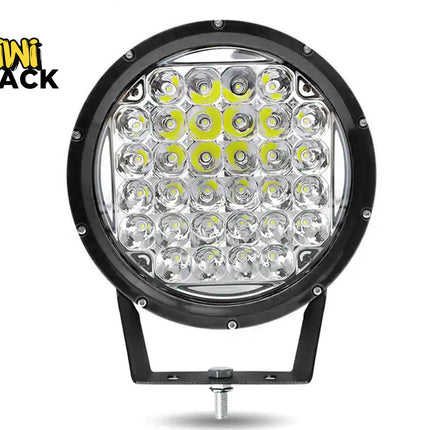 A round black LED off-road light with a mounting bracket, shown on a white background with a Kiwi Shack logo in the top-left corner.