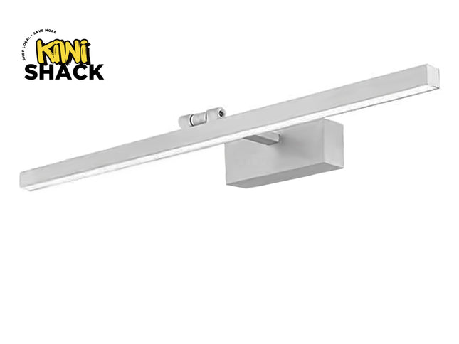Modern linear LED vanity / picture light with a brushed silver/aluminum finish, rectangular mounting block, pivoting joint, integrated LED strip along the underside, and Kiwi Shack logo watermark.