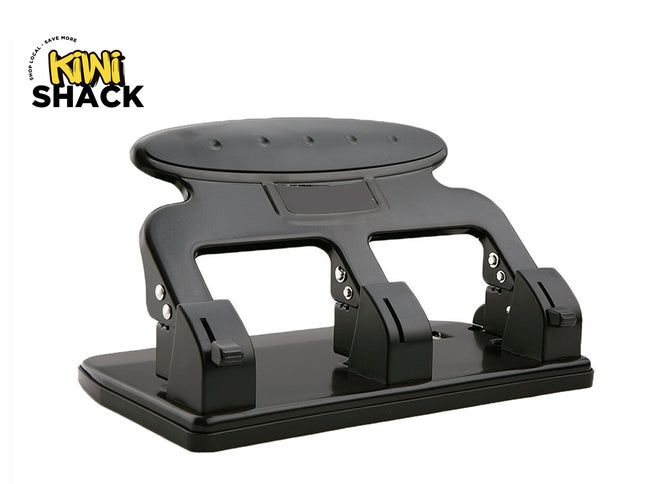 Black heavy-duty multi-hole paper puncher (3-hole or multi-punch mechanism) with an ergonomic wide handle plate, base alignment guide, and the Kiwi Shack logo watermark.