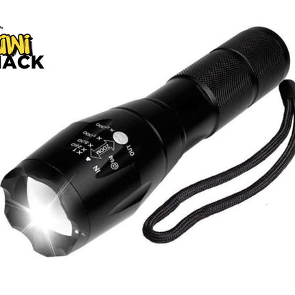 Black flashlight with visible light on a white background, featuring the Kiwi Shack logo.