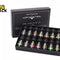 A gift set of 14 dark glass essential oil bottles arranged neatly inside an open black presentation box with white lettering, set against a white background. A "Kiwi Shack" logo appears in the top-left corner.