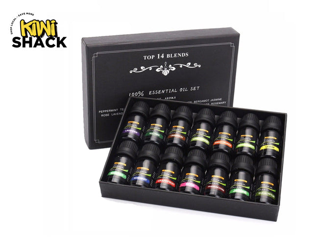 A gift set of 14 dark glass essential oil bottles arranged neatly inside an open black presentation box with white lettering, set against a white background. A "Kiwi Shack" logo appears in the top-left corner.