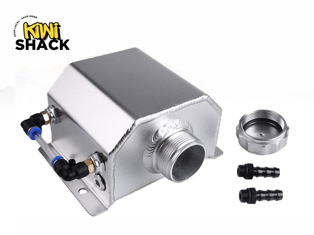 A silver aluminum oil catch can featuring visible welded seams, a side-mounted sight tube with black and blue push-connect fittings, a threaded central inlet port, a threaded cap, and two barbed hose fittings, set against a white background. A "Kiwi Shack" logo appears in the top-left corner.