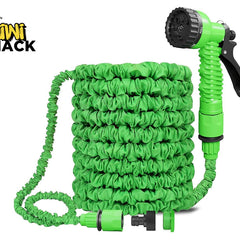 A green expandable garden hose coiled neatly with a matching spray nozzle and connectors, featuring the "Kiwi Shack" logo in the top-left corner.