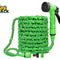A green expandable garden hose coiled neatly with a matching spray nozzle and connectors, featuring the "Kiwi Shack" logo in the top-left corner.