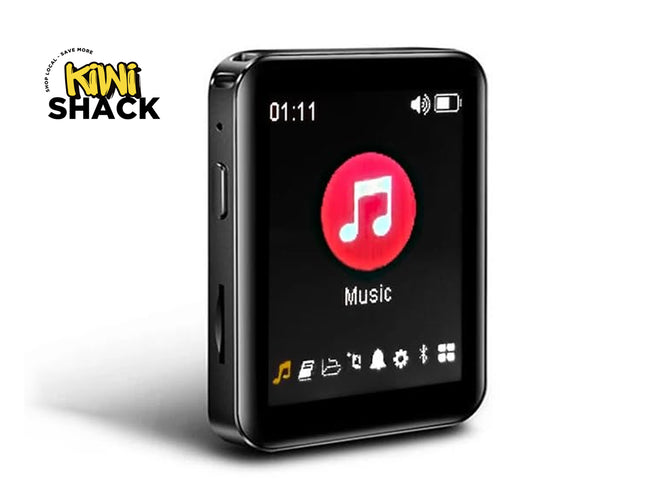 A black rectangular portable music player with rounded corners, shown at a three-quarter angle on a white background. The screen displays a music player interface with a red circle containing a white music note and the word 'Music'.