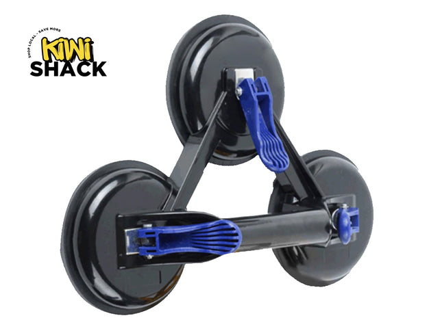 A heavy-duty triple suction cup dent puller and glass lifter with black pads, a rigid triangular frame, and blue quick-release locking levers against a white background, featuring the "Kiwi Shack" logo in the upper left corner.