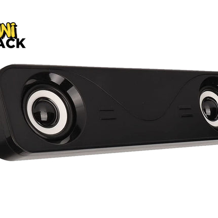 A sleek black rectangular computer soundbar with two exposed speakers featuring white trim rings, set against a white background. A "Kiwi Shack" logo appears in the top-left corner.