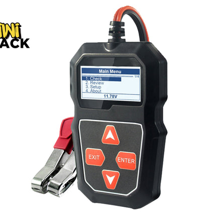 A black digital car battery tester with a color display showing a "Main Menu" and control buttons below, connected to heavy-duty red and black battery clamps, featuring a "Kiwi Shack" logo in the top left corner.