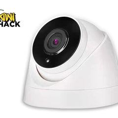 White security camera with black lens on a white background, featuring the Kini Shack logo.