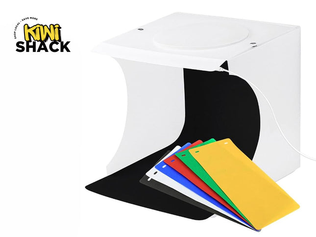 Kiwi Shack portable LED photo studio light box kit for product photography with multi-color backdrop inserts and built-in lighting.