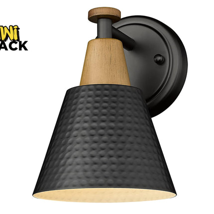 Modern farmhouse-style black and wood accent wall sconce with a hammered metal shade, round backplate, and Kiwi Shack logo watermark.