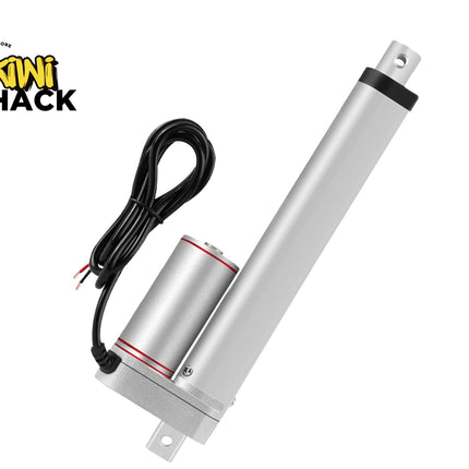 A silver linear electric motor with an attached black power cable, shown on a plain white background with the Kiwi Shack logo in the top-left corner.