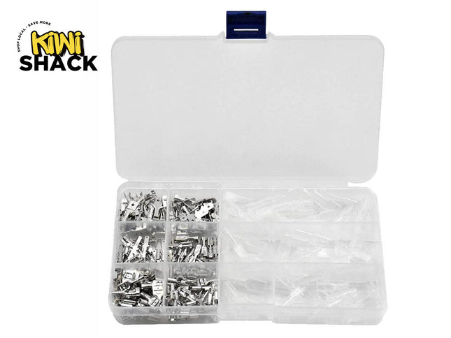 An open clear plastic compartmentalized storage box containing assorted metal spade wire terminals and transparent insulating sleeves, set against a white background. A "Kiwi Shack" logo appears in the top-left corner.