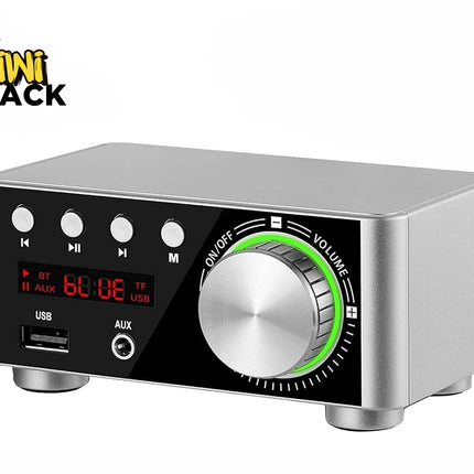 A compact silver and black digital audio amplifier box featuring a large central volume knob with an illuminated green ring, control buttons, a red LED display screen, and front USB and AUX ports, with a "Kiwi Shack" logo in the top left corner.