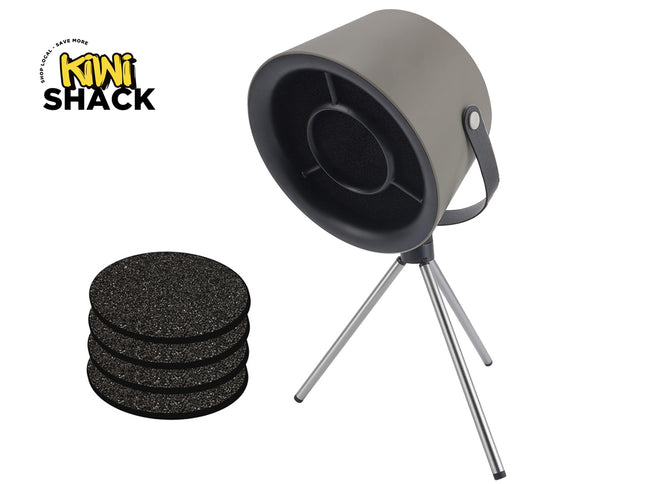 A gray cylindrical electronic acoustic sound machine on a silver tripod stand with a carrying strap, accompanied by a stack of four black textured acoustic foam filter pads to its left, set against a white background with the "Kiwi Shack" logo in the top left corner.