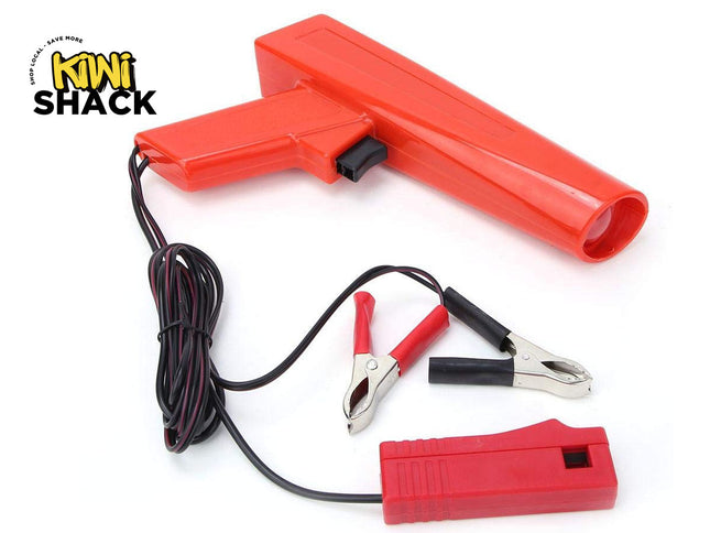 Red battery jump starter with clamps on a white background, branded 'Kiwi Shack'.