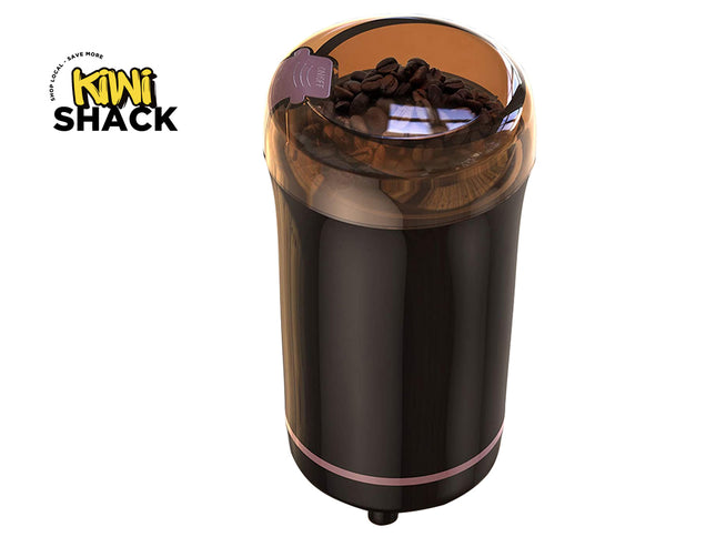 Coffee grinder with coffee beans on a white background, featuring the Kiwi Shack logo.
