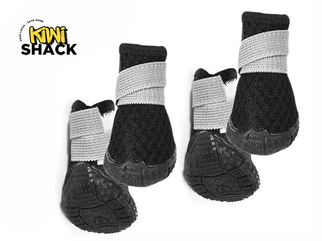 A set of four black dog booties featuring textured rubber soles and adjustable gray strap closures, set against a white background with the "Kiwi Shack" logo in the top left corner.
