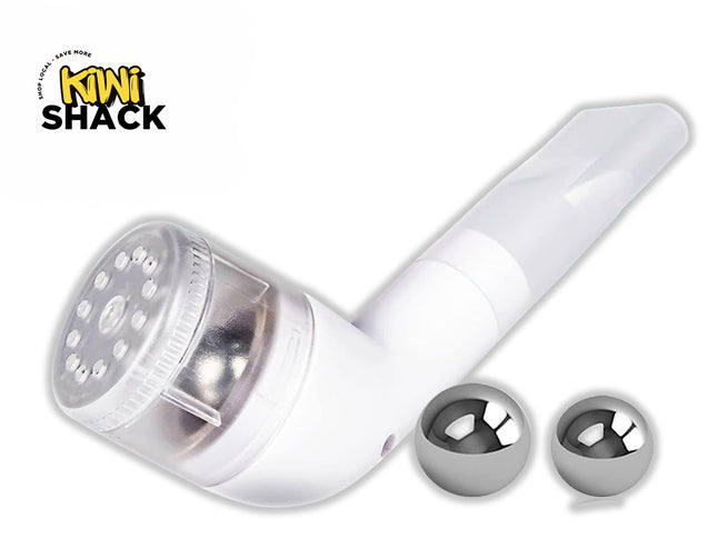 A white handheld pipe-style smoking device with a clear bowl cover and two polished steel metal balls resting next to it, set against a white background. A "Kiwi Shack" logo appears in the top-left corner.