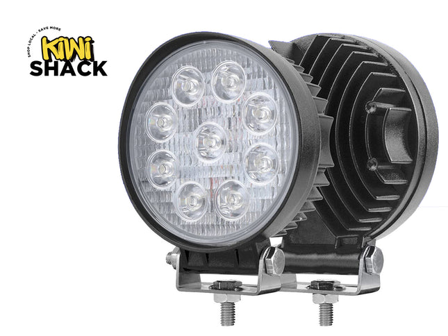 Round LED work light with black housing on a white background, featuring the Kiwi Shack logo.