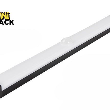 A slim, elongated LED under-cabinet light bar with a black base and a frosted white cover featuring a small motion sensor dome in the center, and a charging port visible on the end cap, with a "Kiwi Shack" logo in the top left corner.