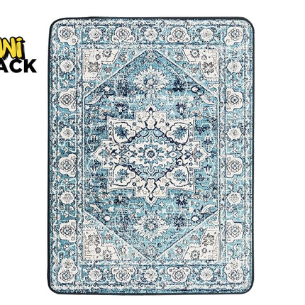A rectangular area rug with a distressed traditional pattern in shades of blue, navy, and cream, shown flat against a white background with a Kiwi Shack logo in the top-left corner.