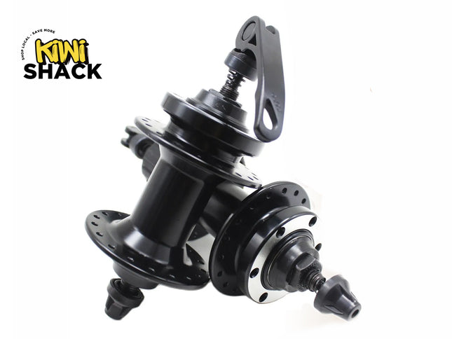 A pair of black bicycle wheel hubs with drilled spoke flanges and quick-release skewers, featuring a "Kiwi Shack" logo in the top left corner.