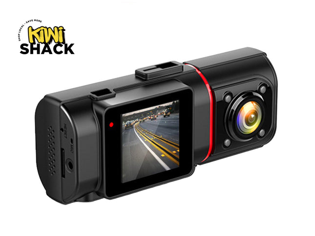 Car dashboard camera with screen displaying road view, branded 'Kiwi Shack'.