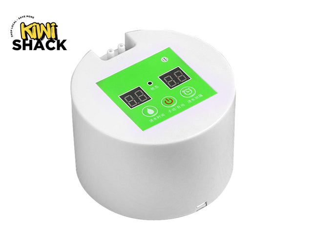 A white automatic smart watering timer pump device featuring a green control panel with dual digital displays, touch buttons, and dual water inlet/outlet ports on top against a white background, featuring the "Kiwi Shack" logo in the upper left corner.