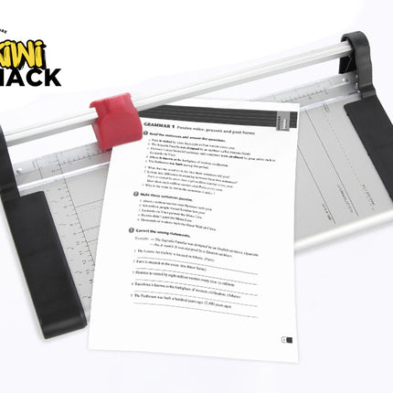 Paper cutter with a piece of paper on a white background, featuring the Kiwi Shack logo.