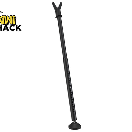 Matte black adjustable shooting stick / rifle rest mono-pod with a V-shaped upper cradle, a vertical height-adjustment section with pin adjustment holes, a flat circular rubber foot, and Kiwi Shack logo in top left.