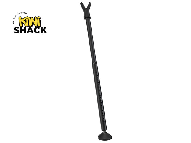 Matte black adjustable shooting stick / rifle rest mono-pod with a V-shaped upper cradle, a vertical height-adjustment section with pin adjustment holes, a flat circular rubber foot, and Kiwi Shack logo in top left.