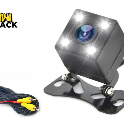 A compact black backup camera with four LED lights, an adjustable mounting bracket, and a video cable with yellow RCA connectors, featuring the "Kiwi Shack" logo in the top-left corner.