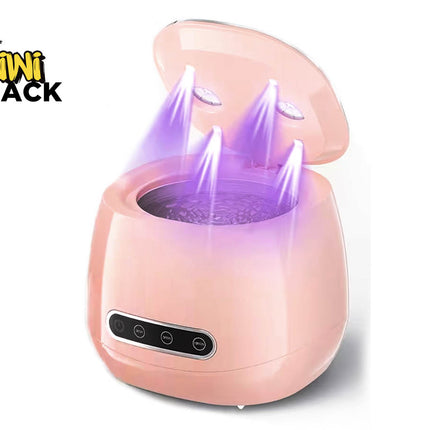 Pink ultrasonic jewelry/lens cleaner machine with open lid showing purple ultraviolet disinfecting lights beaming down into a vibrating water basin, front control panel with timer buttons, and Kiwi Shack logo in top left.