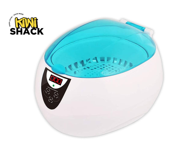A white foot bath or ultrasonic cleaner with a translucent light blue interior and a black control panel featuring a digital display screen. The brand logo 'KIWI SHACK' is visible in the top-left corner.