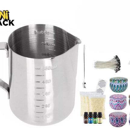 Stainless steel candle-making pouring pitcher / measuring jug with embossed volume markings, side handle, accompanied by candle wicks, wick centering tools, wick sticker pads, wax flakes/pellets, fragrance oil bottles, and decorative patterned tin containers with lids, plus the Kiwi Shack logo watermark.