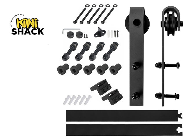 A black metal sliding barn door hardware kit from Kiwi Shack, laid out on a white background with the brand logo in the top left corner. The kit includes the door, roller assembly, track brackets, bolts, washers, and mounting hardware.