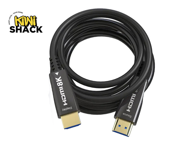A coiled black HDMI cable with gold and blue connector ends, shown on a white background with a Kiwi Shack logo in the top-left corner.