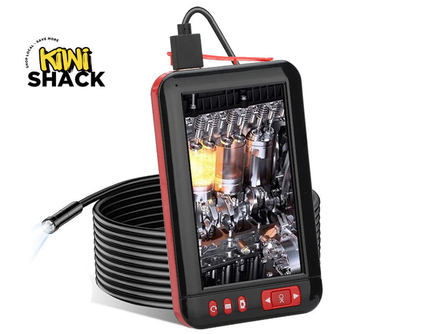 A black and red handheld engine inspection camera with a coiled black cable, displaying an engine view on its screen. The Kiwi Shack logo is visible in the top-left corner.