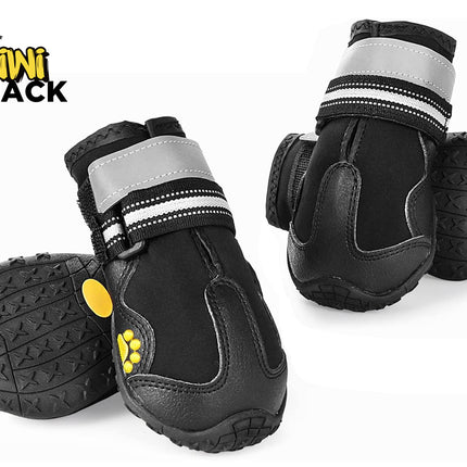 Set of black protective dog boots showing bottom lug soles, rubber toe caps, dual reflective and striped Velcro straps, yellow paw details, and Kiwi Shack logo watermark.