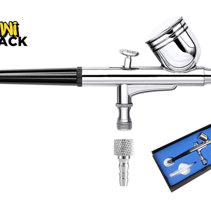 Chrome-plated double-action gravity feed airbrush featuring a black grip handle, top gravity fluid cup with lid, trigger control, air inlet fitting, separate knurled hose adapter nozzle, a blue-lined presentation storage box showing the kit contents, and the Kiwi Shack logo watermark.