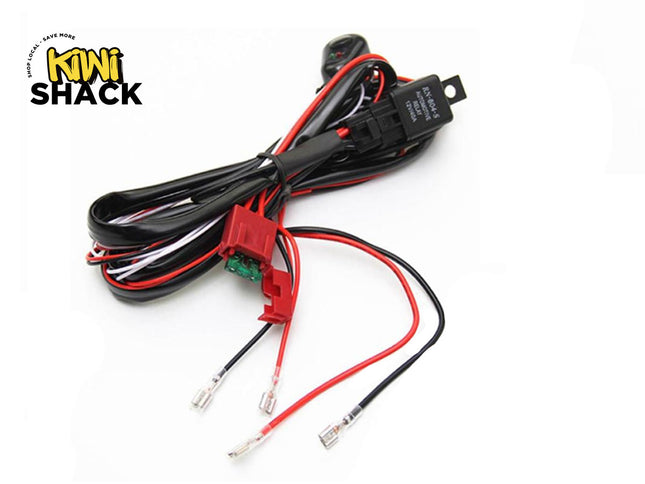 An automotive wiring harness kit with a relay, inline fuse holder, switch, and connector leads, featuring the "Kiwi Shack" logo in the top-left corner.